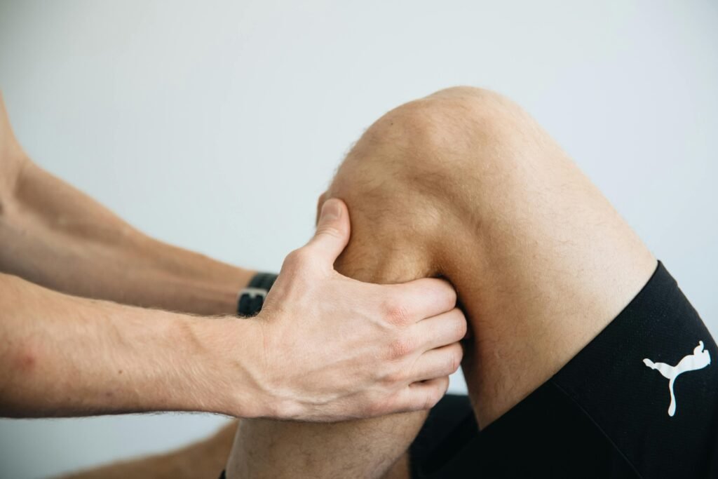 pexels-photo-20860607-20860607 Detailed image of a physiotherapy session focusing on knee massage treatment.